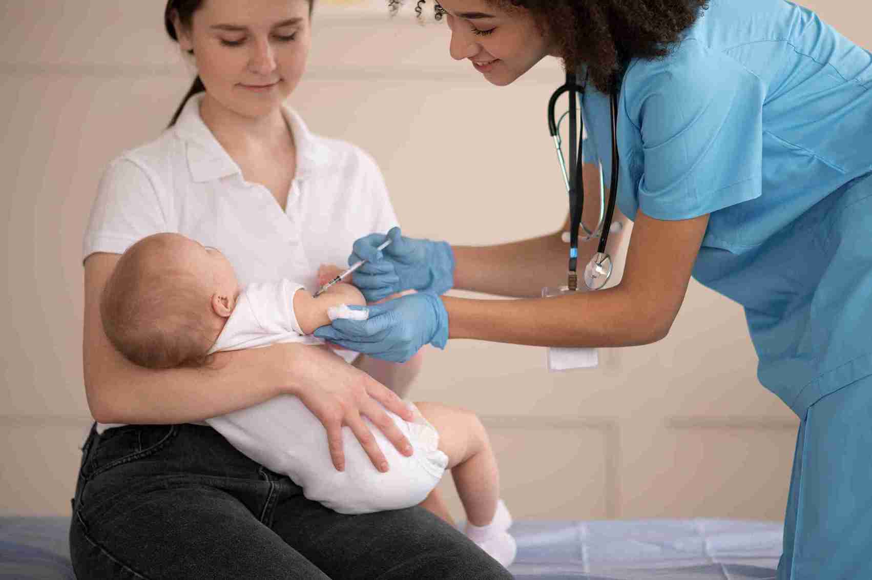 Mother holding her newborn baby with nursing support at home